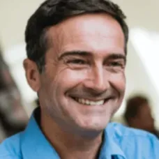 Close-up portrait of a smiling middle-aged male consumer displaying authentic satisfaction after achieving enhanced physical energy parameters.